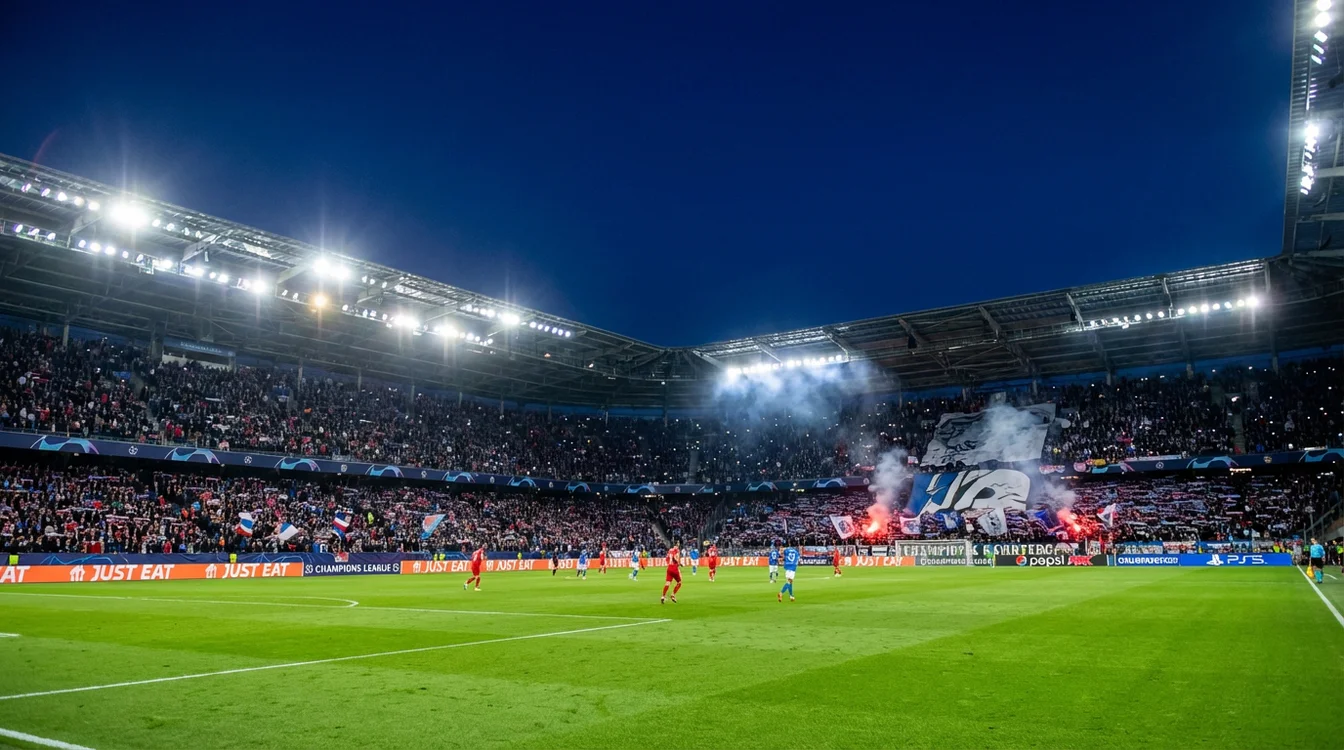 Estádio de futebol iluminado durante uma noite de Champions League com adeptos nas bancadas