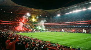 Estádio de futebol português cheio de adeptos durante um jogo nocturno